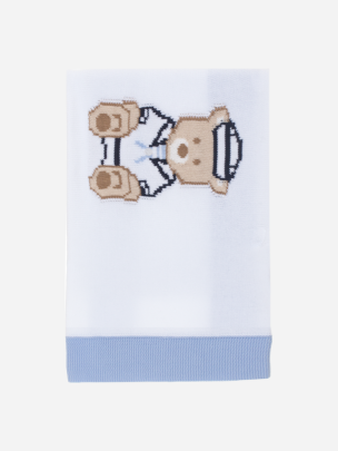 White and blue knitted blanket with teddy bear