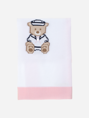 Pink knitted blanket with teddy bear